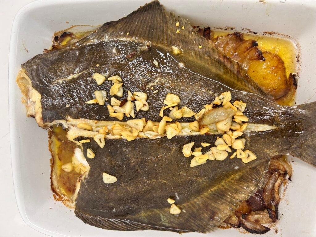 rèmol al forn amb patates ceba i alls daurats